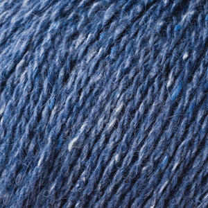Skein of Rowan Felted Tweed DK DK weight yarn in the color Seasalter (Blue) for knitting and crocheting.