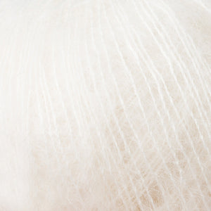 Skein of Rowan Kidsilk Haze Lace weight yarn in the color Cream (Cream) for knitting and crocheting.