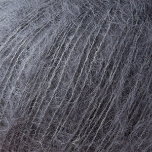 Skein of Rowan Kidsilk Haze Lace weight yarn in the color Smoke (Gray) for knitting and crocheting.