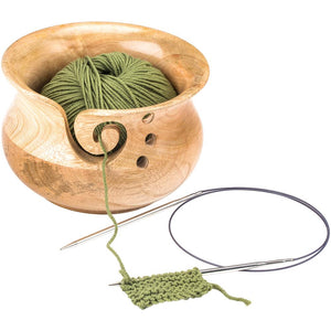 Susan Bates Mangowood Yarn Bowl holding green yarn on a knitting needle